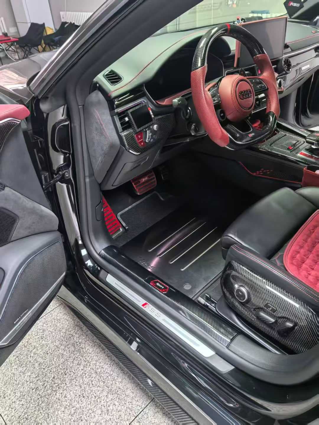 Actual custom ribbed metal floor mat installed in a red and black performance-car interior